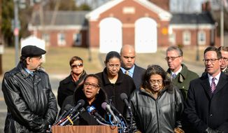 &#39;Too many&#39; The family of Medric Cecil Mills Jr. surrounds attorney Karen Evans as she says they are fighting the District not only on behalf of the man who died after medics refused to treat him, but also for other casualties of the city&#39;s public duty doctrine. (Andrew Harnik/The Washington Times)