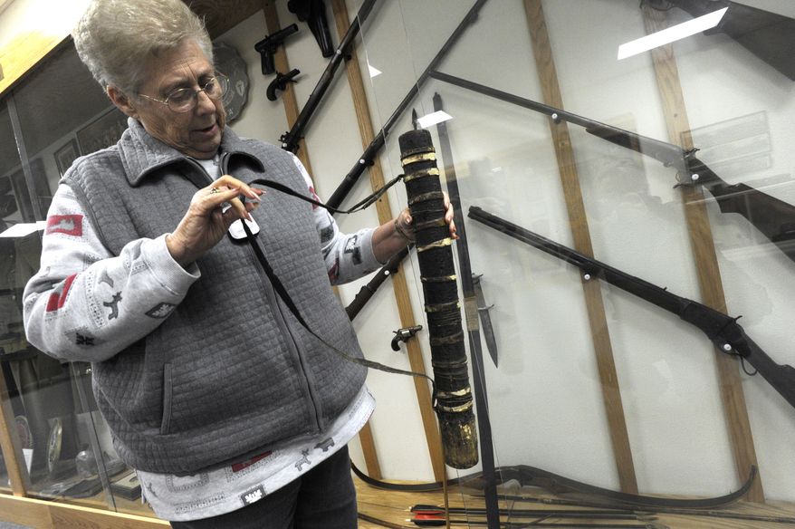 Cowboy Country Museum Curator Sandra Rhea holds a quiver donated to the museum made from a pecan limb and rawhide, Wednesday Jan. 30, 2014. The museum is located in Stamford. (AP Photo/The Abilene Reporter-News, Ronald W. Erdrich)