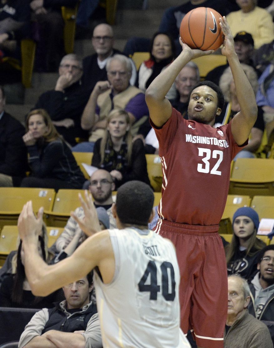 Washington State's Que Johnson (32) shoots in front of Josh Scott during an NCAA basketball game on Wednesday, Feb. 5, 2014, in Boulder, Colo. (AP Photo/The Daily Camera, Jeremy Papasso) NO SALES