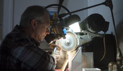 Dennis Smith operates a hand grinder at Fullerton Tool  Jan. 21, 2014 in Saginaw. Smith has been working with Fullerton Tool for 35 years. (AP Photo/The Saginaw News, Tim Goessman)