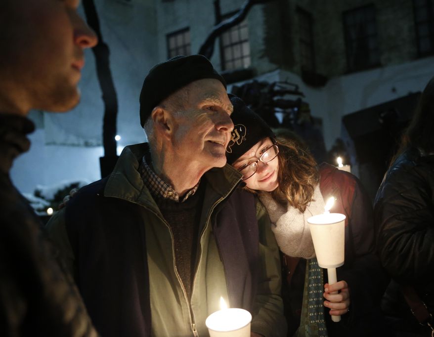 People hold candles during a candlelight vigil and remembrance for actor Philip Seymour Hoffman, who died Sunday of a suspected drug overdose, Wednesday, Feb. 5, 2014, in New York.  Sponsored by the Labyrinth Theater Company, the vigil  was held in the courtyard behind the Bank Street theater. Hoffman was a member and former artistic director of Labyrinth. (AP Photo/Kathy Willens)