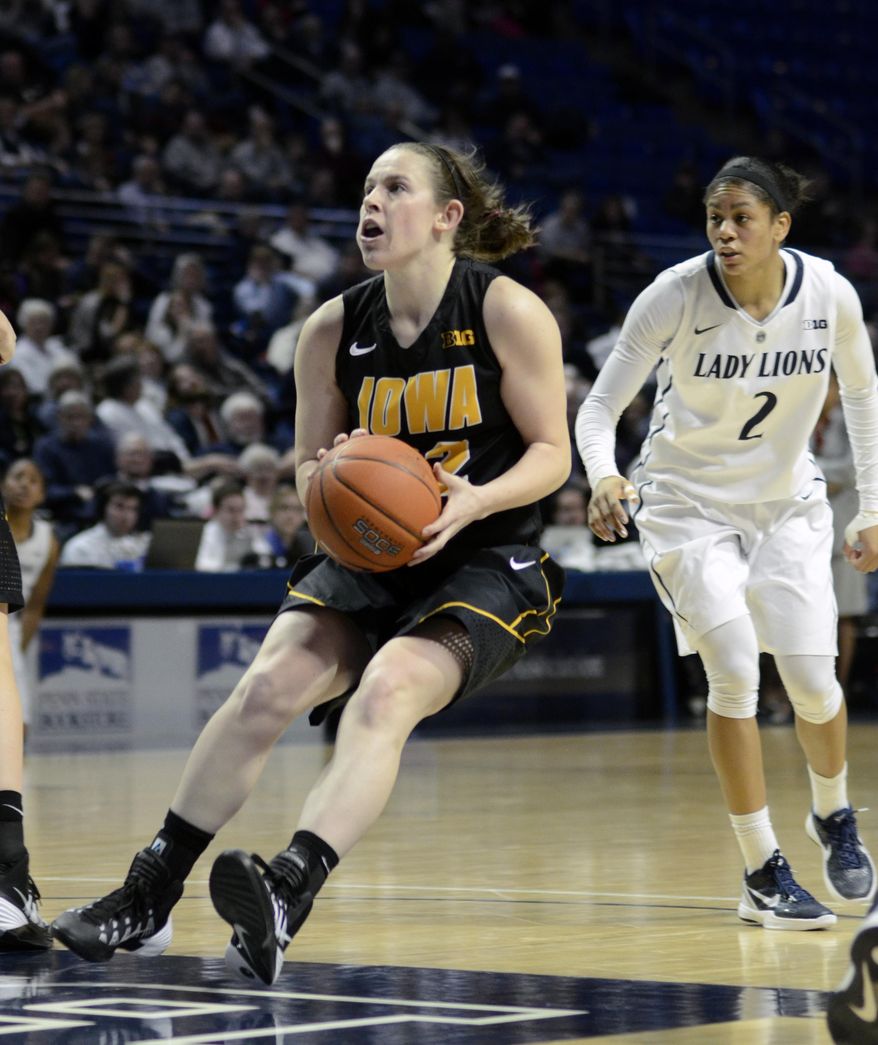 Iowa's Samantha Logic (22) moves into the paint during the second half of an NCAA college basketball game on Thursday, Feb. 6, 2014 in State College, Pa. (AP Photo/Ralph Wilson)