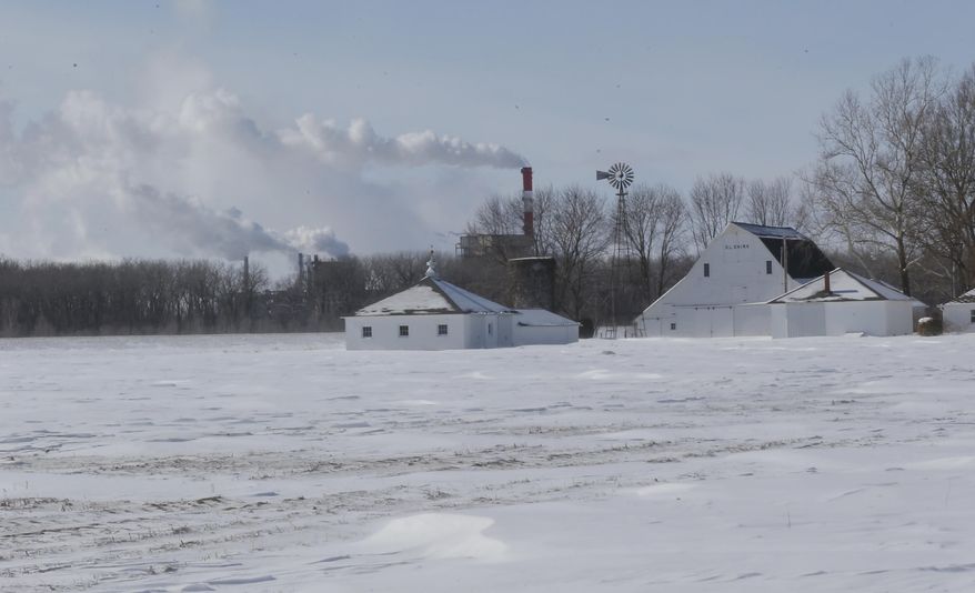 The Lawrence Energy Center produces electrical power in the background of Shirks Farm near Lawrence, Kan., Wednesday, Feb. 5, 2014. (AP Photo/Orlin Wagner)