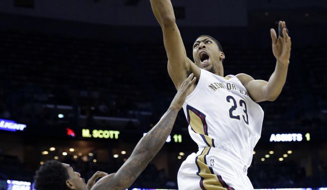 New Orleans Pelicans power forward Anthony Davis (23) goes to the basket over Atlanta Hawks shooting guard Louis Williams (3) in the second half of an NBA basketball game in New Orleans, Wednesday, Feb. 5, 2014. The Pelicans won 105-100. (AP Photo/Gerald Herbert)