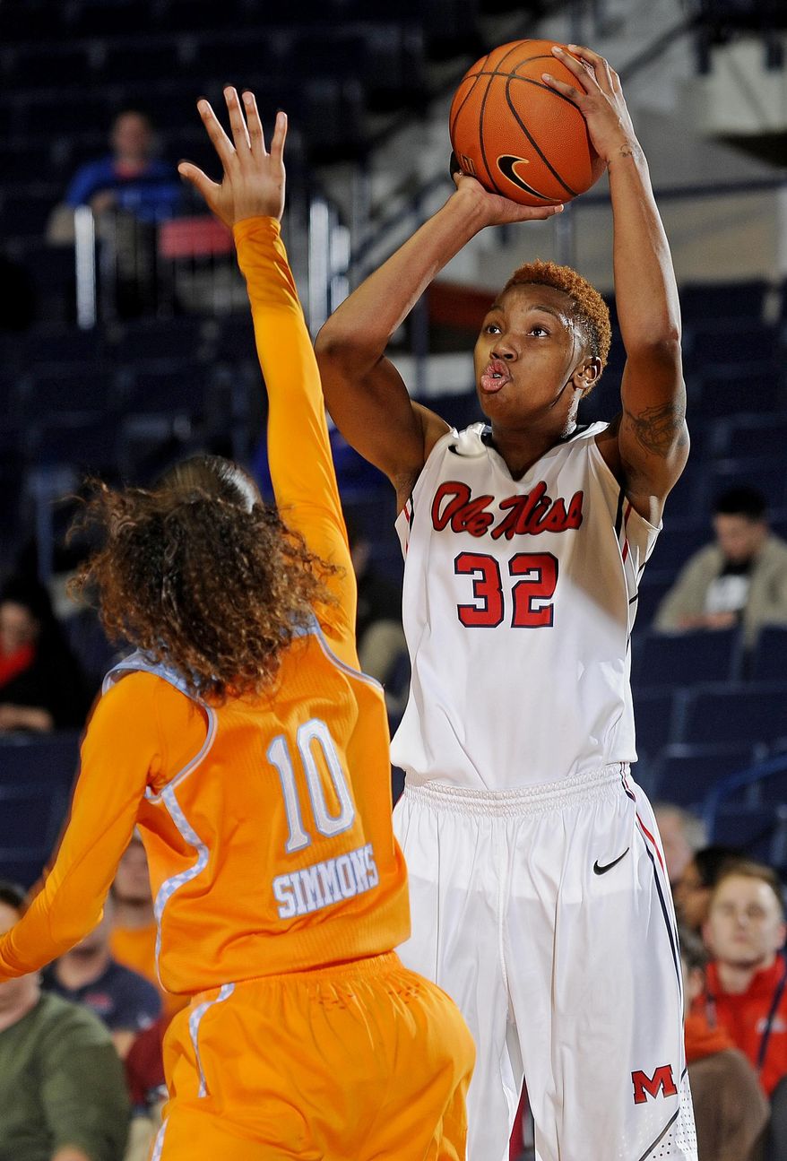 Mississippi forward Tia Faleru (32) goes up for a shot past Tennessee guard Meighan Simmons (10) during the first half of an NCAA college basketball game in Oxford, Miss., Thursday, Feb. 6, 2014. (AP Photo/Thomas Graning)