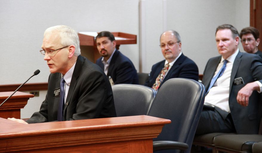 Rep. Scott Ecklund, R-Brandon, left, a physician and sponsor of the bill to provide prenatal care to immigrant women who are not citizens, speaks during a committee hearing Thursday, Feb 6, 2014 in Pierre, S.D. The South Dakota House Health and Human Services Committee passed a measure Thursday that would provide prenatal care to low-income women who are in the country illegally. The bill would authorize an expansion of Medicaid services for pregnant women who didn't previously qualify because of their legal status. Supporters of the measure say it will increase the survival rate of children and save the state money in the long term by providing preventative care. Behind Ecklund at right is Rep. Bernie Hunhoff, D-Yankton, and next to Hunhoff is Pediatrician and neonatal specialist Dr. Lawrence Fenton. (AP Photo/Jill Kokesh)