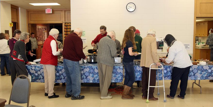 FOR RELEASE SATURDAY, FEB. 8, 2014, AT 12:01 A.M. CST. AND THEREAFTER - In this Jan. 25, 2014 photo, people line up to receive breakfast at Ceil's Meal at First Congregational Church in Sheboygan, Wis. About four times a year, on the fifth Saturday of the month, First Congregational Church, UCC welcomes the public to a free breakfast, called Ceil's Meal. (AP Photo/The Sheboygan Press, Gary C. Klein)