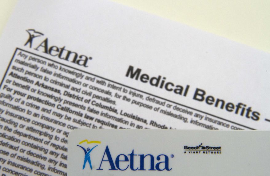 FILE - This Jan. 30, 2012 file photo, shows an Aetna benefits card in Surfside, Fla. Aetna reports quarterly earnings on Thursday, Feb. 6, 2014. (AP Photo/Wilfredo Lee, File)