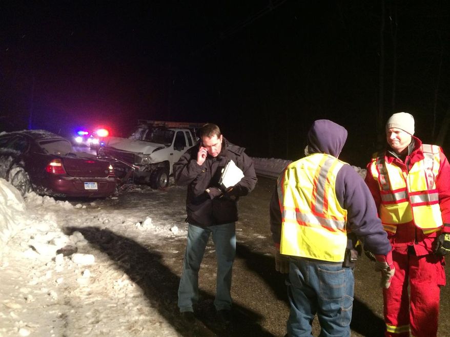 Mason County Sheriff’s Office Chief Deputy Steve Hansen walks away from the wreckage of the fatal crash Wednesday, Feb. 5, 2014, as Hamlin Township Fire Chief Steve Vandervest and firefighter Andy Larr discuss the scene near Hamlin Township, Mich. Authorities say a woman and her baby are dead following a two-vehicle crash, that left the baby's 7-year-old sibling in critical condition. Amanda Collins, 28, and 10-month-old Lillian Grace Collins died following the crash around 5:30 p.m. Wednesday in Mason County's Hamlin Township, about 80 miles northwest of Grand Rapids. The other child, identified as Madysen Marie Church, was flown to a Grand Rapids hospital. (AP Photo/Ludington Daily News, Patti Klevorn) MANDATORY CREDIT