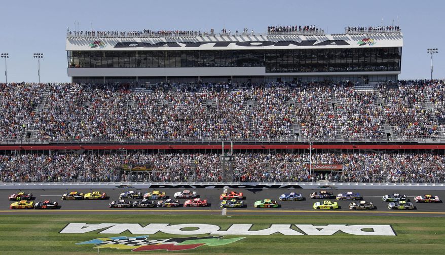 FILE - In this Feb. 20, 2011, file photo, Jeff Gordon and Kurt Busch lead the field at the start of the Daytona 500 NASCAR auto race at Daytona International Speedway in Daytona Beach, Fla. Toyota Motor Corp. is the first company to land naming rights at the revamped Daytona International Speedway. The Japanese automaker and International Speedway Corp., which owns the famous Florida track, announced the deal Thursday, Feb. 6, 2014, at the Chicago Auto Show. (AP Photo/Lynne Sladky, File)