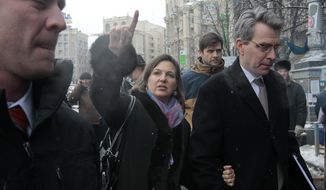 U.S. Assistant Secretary for European and Eurasian Affairs Victoria Nuland, center, gestures as she and U.S. Ambassador to Ukraine Geoffrey Pyatt, right, walk through the Independence Square in Kiev, Ukraine, Tuesday, Dec. 10, 2013. Top Western diplomats headed to Kiev Tuesday to try to defuse a standoff between President Viktor Yanukovych&#39;s government and thousands of demonstrators, following a night in which police in riot gear dismantled protesters&#39; encampments outside government buildings. (AP Photo/Sergei Chuzavkov)