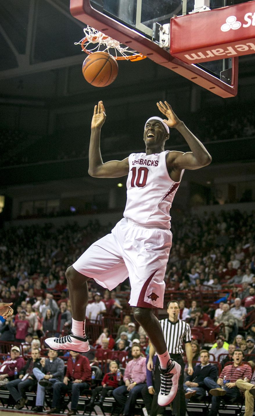 Arkansas forward Bobby Portis (10) slams an alley-oop dunk during the first half of an NCAA college basketball game against Alabama, Wednesday, Feb. 5, 2014, in Fayetteville, Ark. Arkansas defeated Alabama 65-58. (AP Photo/Gareth Patterson)