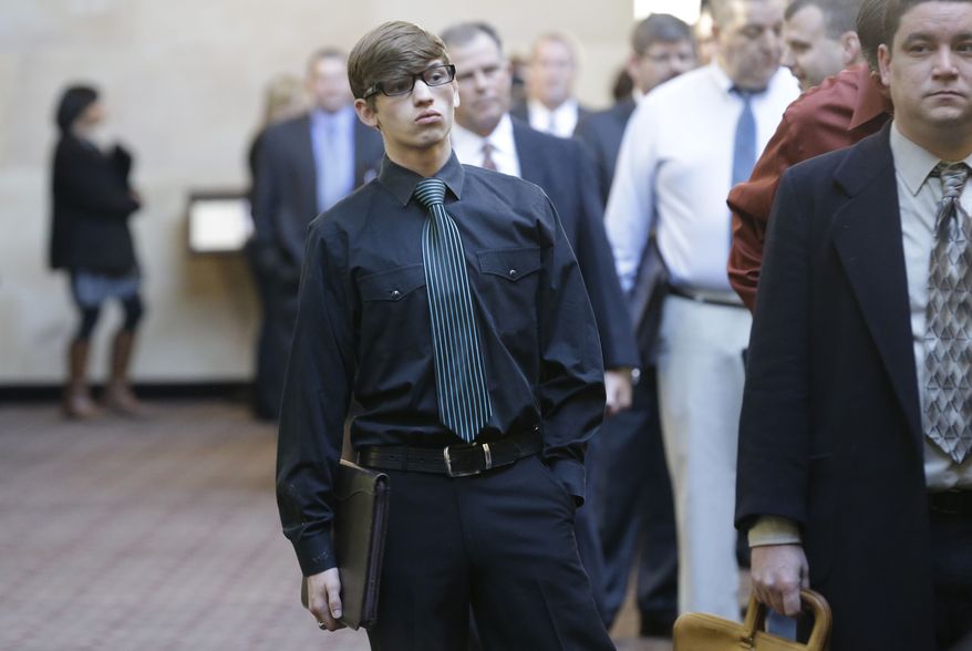 ** FILE ** In this Wednesday, Jan. 22, 2014, photo, Austin Moore, 18, lines up with other job seekers during a career fair at a hotel in Dallas. (AP Photo/LM Otero)