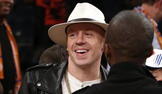Rapper Macklemore attends an NBA basketball game between the Miami Heat and the New York Knicks Saturday, Feb. 1, 2014, in New York.  Miami won 106-91. (AP Photo/Jason DeCrow)