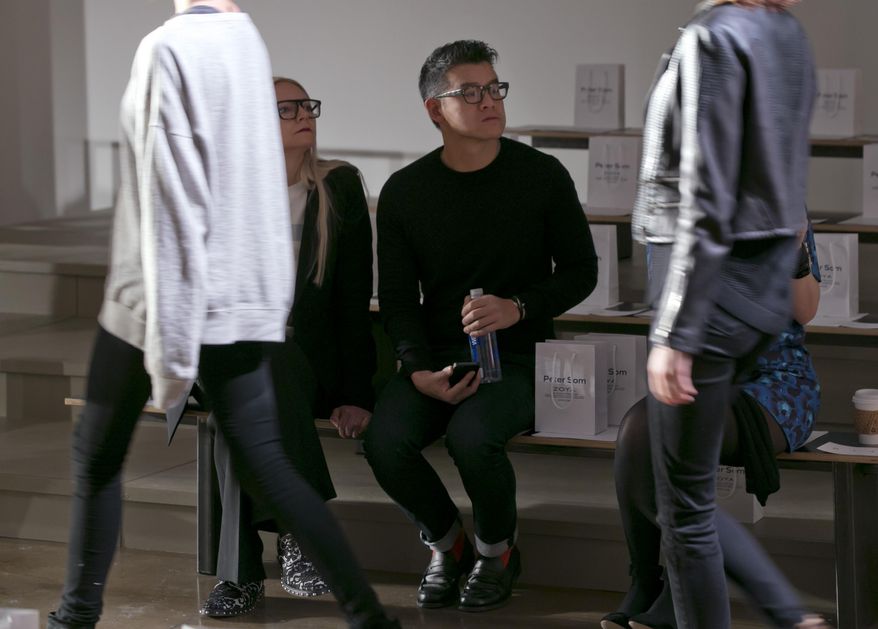 Designer Peter Som watches the rehearsal before his Fall 2014 collection is modeled during Fashion Week in New York,  Friday, Feb. 7, 2014. (AP Photo/Richard Drew)