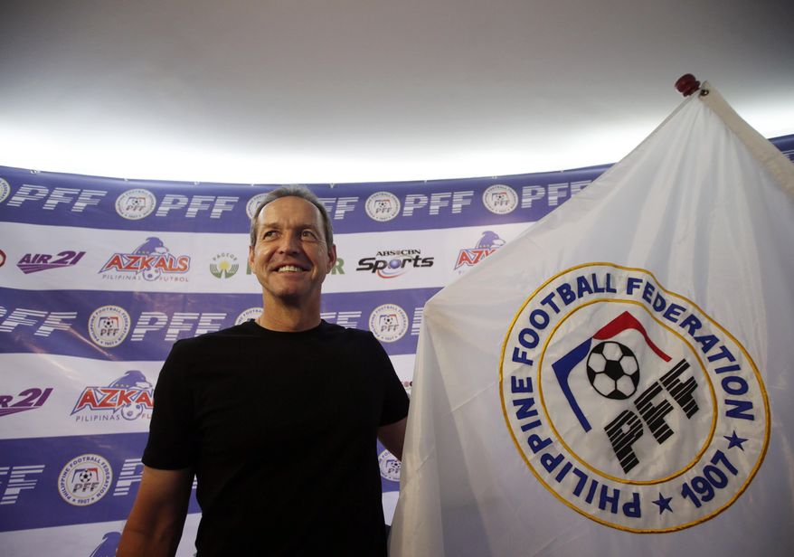 Former U.S. captain Thomas Dooley poses for photographers following his appointment as the new head coach of the Philippine national football team known as "Azkals" Friday, Feb. 7, 2014 at suburban Pasig city, east of Manila, Philippines. Dooley, who replaced German coach Michael Weiss, will start immediately preparing the team for the Challenge Cup in May in the Maldives. It will be Dooley's first time to coach a national team and he said he is "very honored, humbled and very excited to take this task." (AP Photo/Bullit Marquez)