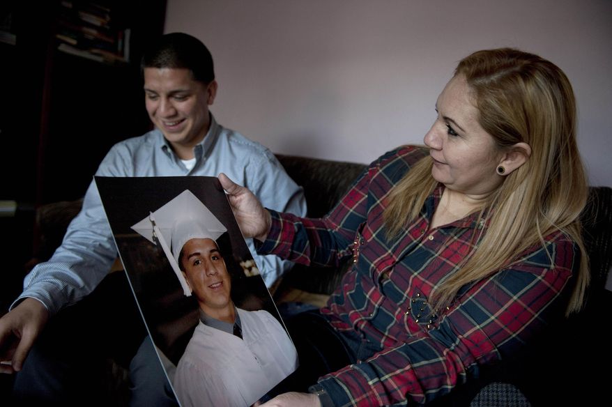 In this Wednesday, Dec. 25, 2013 photo, Melba Soza holds a graduation photo of her son, Jose Antonio, at her apartment in Basauri, Spain during his five-day visit. The last time he saw his mother in the U.S., she was dressed in an orange jumpsuit, wrists in handcuffs at a Miami courthouse. Machado was brought to Miami as an undocumented immigrant from Nicaragua when he was six years old. He grew up in Miami with his mother who was also undocumented. She was deported in 2011 after a traffic stop on the drive home from work. (AP Photo/Alvaro Barrientos)