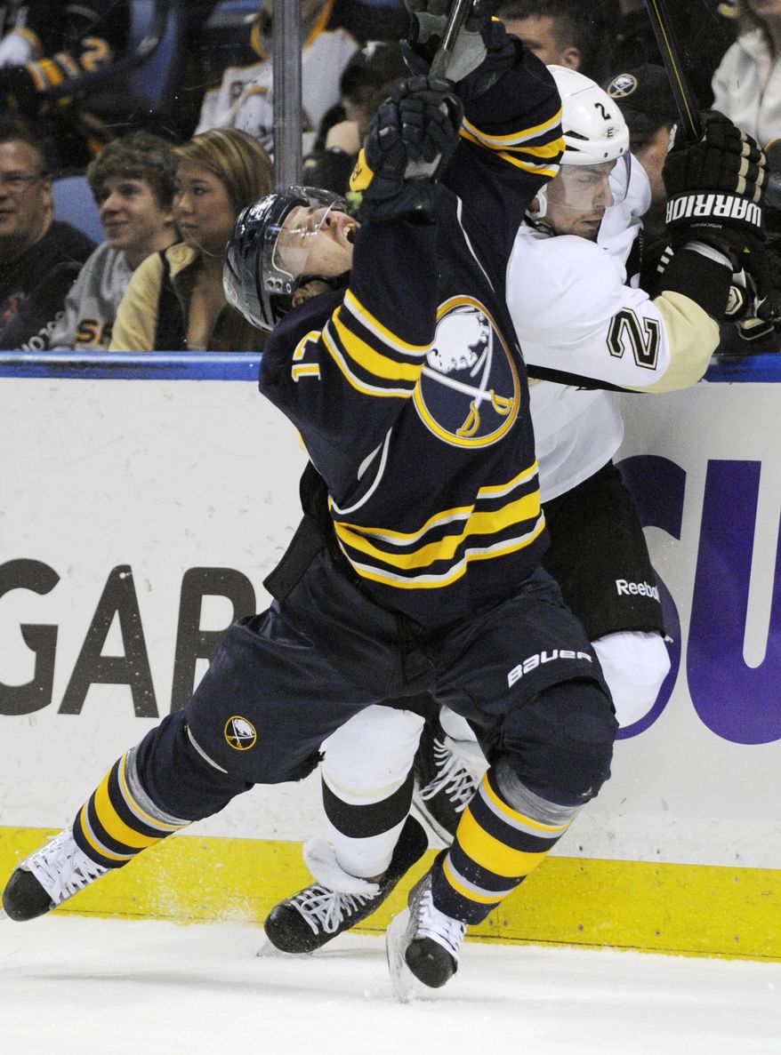 Buffalo Sabres' Linus Omark (17), of Sweden, grimaces after a check on Pittsburgh Penguins' Matt Niskanen (2) during the first period of an NHL hockey game in Buffalo, N.Y., Wednesday, Feb. 5, 2014. Pittsburg won 5-1. (AP Photo/Gary Wiepert)