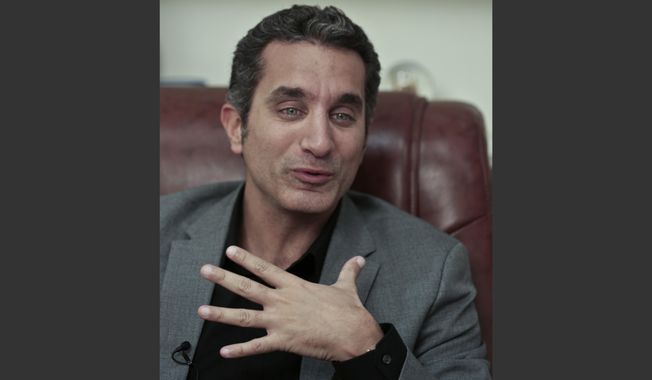 FILE - In this file photo taken Wednesday, Jan. 8, 2014, Egyptian Satirist Bassem Youssef speaks during an interview with The Associated Press in Cairo, Egypt. Youssef was back on air on Friday, Feb. 7, true to his style of mocking the euphoria gripping Egyptians surrounding the country&#x27;s military chief Abdel-Fattah el-Sissi, who is widely expected to run for president. Private broadcaster CBC had suspended Youssef&#x27;s show last fall after the season&#x27;s first episode, but he returned on a different broadcaster. (AP Photo/Nariman El-Mofty, File)