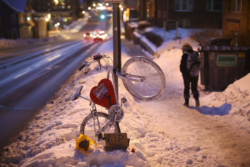 The ghost bike tribute to Marcus Nalls, 26, at the spot on W. Franklin Ave. in Minneapolis, where he was struck and killed by a van on Monday night while riding his bicycle. This photo was made Thursday Feb. 6, 2014. (AP Photo/The Star Tribune, Jeff Wheeler)
