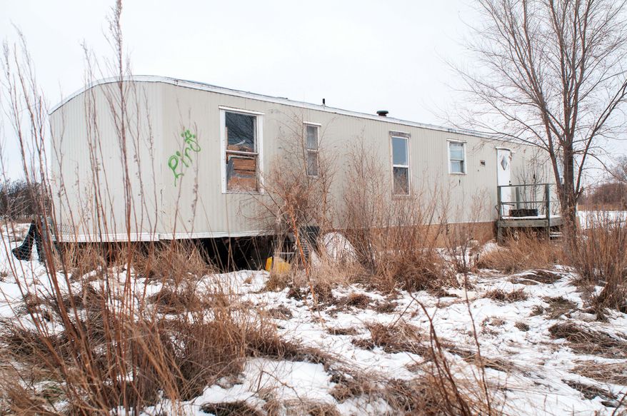 In this Thursday, Feb. 6, 2014 photo is a rundown mobile home with an empty propane tank where 61-year-old Debbie Dogskin was found dead on Tuesday at the Standing Rock Reservation in Fort Yates, N.D. A nationwide propane shortage has hit the American Indian reservation that straddles the Dakotas’ border particularly hard. A more than doubling of the fuel’s cost has crippled efforts to stay warm _ and alive _ through the harsh winter where most people rely on propane to heat their often ramshackle homes. (AP Photo/Kevin Cederstrom)