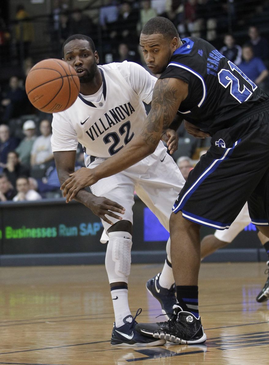 Villanova's JayVaughn Pinkston (22) passes the ball around Seton Hall's Eugene Teague (21) during the first half of an NCAA college basketball game, Friday, Feb. 7, 2014, in Villanova, Pa. (AP Photo/Laurence Kesterson)