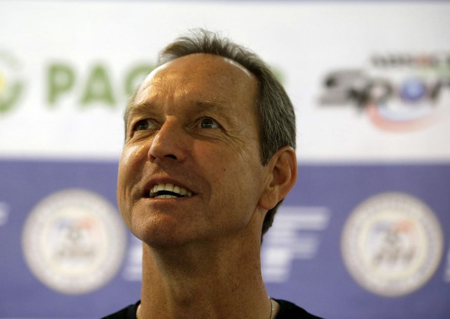 Former U.S. captain Thomas Dooley poses for photographers following his appointment as the new head coach of the Philippine national football team known as "Azkals" Friday, Feb. 7, 2014 at suburban Pasig city, east of Manila, Philippines. Dooley, who replaced German coach Michael Weiss, will start immediately preparing the team for the Challenge Cup in May in the Maldives. It will be Dooley's first time to coach a national team and he said he is "very honored, humbled and very excited to take this task." (AP Photo/Bullit Marquez)