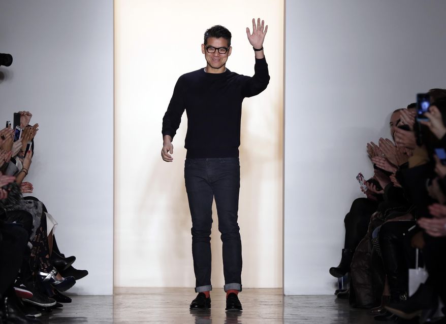 Designer Peter Som acknowledges audience applause after his Fall 2014 collection was modeled during Fashion Week in New York,  Friday, Feb. 7, 2014. (AP Photo/Richard Drew)