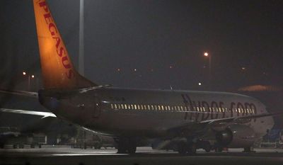 Turkish private company Pegasus passenger plane at the Sabiha Gokcen Airport in Istanbul, Turkey, Friday, Feb. 7, 2014, after a Ukrainian passenger on board Istanbul-bound flight claimed there was a bomb on board and tried to hijack the plane to Sochi, Russia, where the winter Olympics are kicking off, an official said. All 110 passengers aboard the plane were evacuated &quot;without any problems&quot; after authorities subdued the man who attempted to hijack the Turkish plane to Sochi, Russia.(AP Photo/Emrah Gurel)