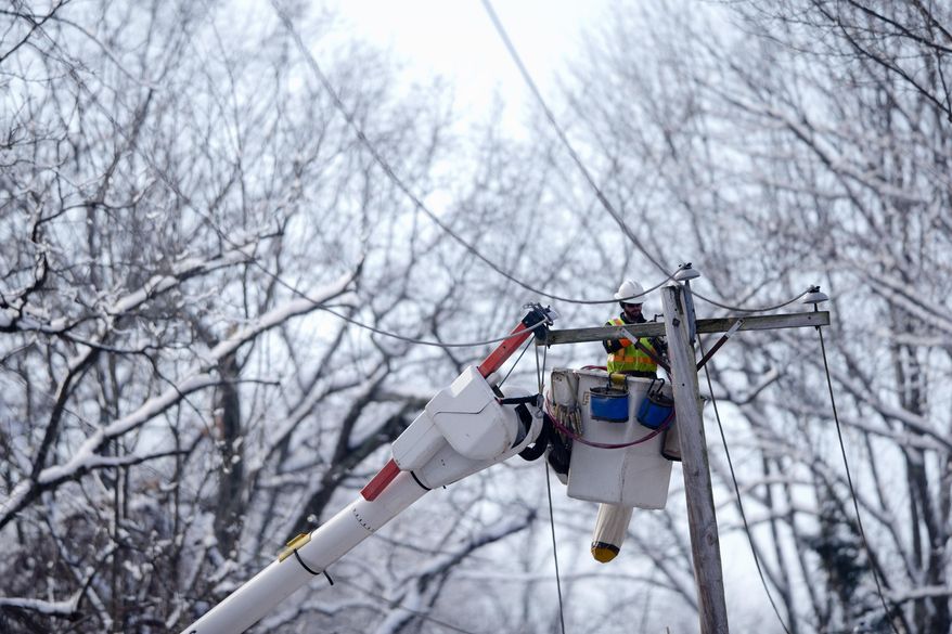 A linesman works to restore electrical power, Friday, Feb. 7, 2014, in Downingtown, Pa. A small army of electricity restoration crews labored Friday to reconnect about 330,000 customers in Pennsylvania and Maryland.  (AP Photo/Matt Rourke)