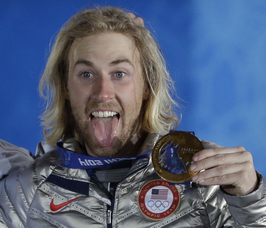Gold medal winner Sage Kotsenburg, of the United States, holds up his medal during the medal ceremony for the Snowboard Men's Slopestyle competition at the 2014 Winter Olympics, Saturday, Feb. 8, 2014, in Sochi, Russia. (AP Photo/David J. Phillip )