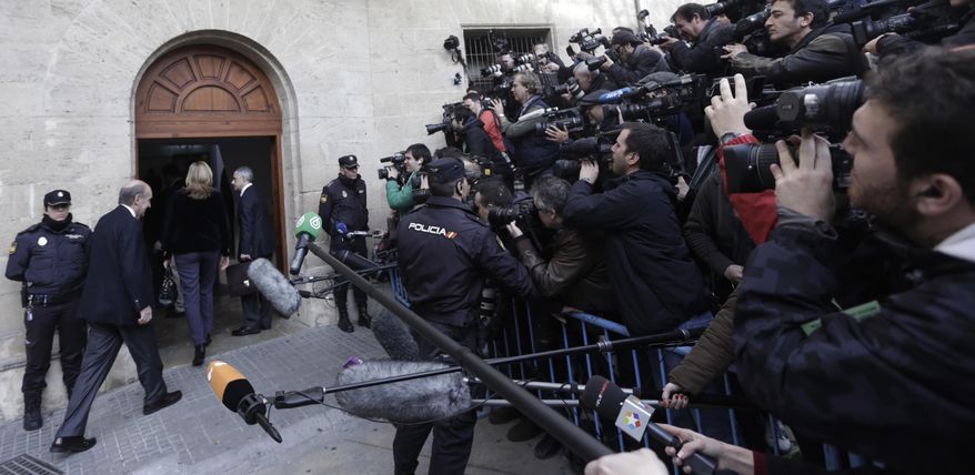 Spain's Princess Cristina, third from left, enters the courthouse in Palma de Mallorca, Spain, Saturday, Feb. 8, 2014. The Spanish princess headed into court on Saturday for a historic judicial hearing to help determine whether she and her husband illegally used funds from a company to pay for expenses, including expensive parties at their modernist Barcelona mansion. Princess Cristina faces questioning by investigating Judge Jose Castro who has named her as a fraud and money laundering suspect. (AP Photo/Manu Mielniezuk)