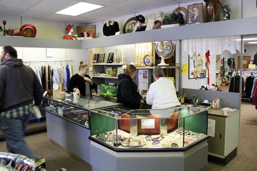 FOR RELEASE SATURDAY, FEB. 8, 2014, AT 12:01 A.M. CST. AND THEREAFTER - In this Saturday, Feb. 1, 2014 photo, customers visit the Bargain Box, a small secondhand shop in Beatrice, Neb. The store is staffed entirely by volunteers, such as Vivian Schuster, right, and Chrissy Garton, center. All profits are donated to MOSAIC in Beatrice, an organization devoted to supporting people with intellectual disabilities. (AP Photo/Beatrice Daily Sun, Casey Welsch)