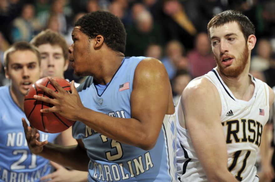 Nortrh Carolina forward Kennedy Meeks, left, grabs a rebound as Notre Dame forward Garrick Sherman defends during the first half of an NCAA college basketball game Saturday, Feb. 8, 2014, in South Bend, Ind. (AP Photo/Joe Raymond)