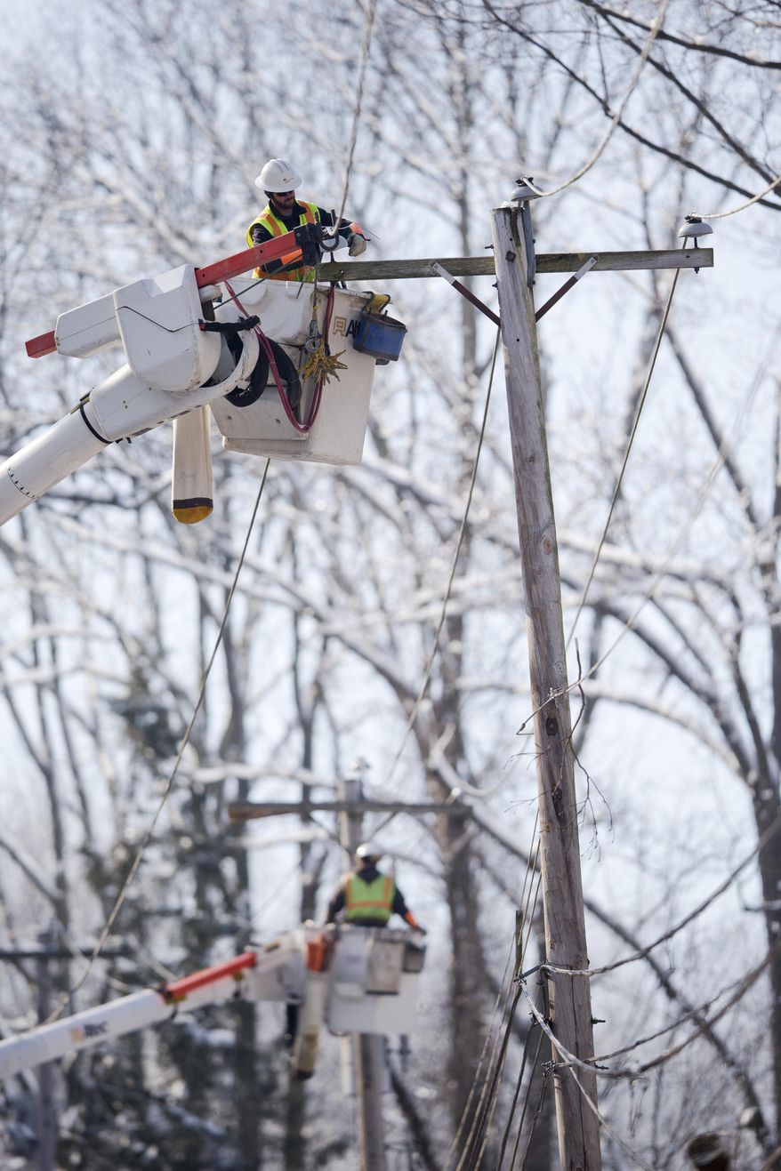 Linesmen work to restore electrical power, Friday, Feb. 7, 2014, in Downingtown, Pa. A small army of electricity restoration crews labored Friday to reconnect about 330,000 customers in Pennsylvania and Maryland.  (AP Photo/Matt Rourke)