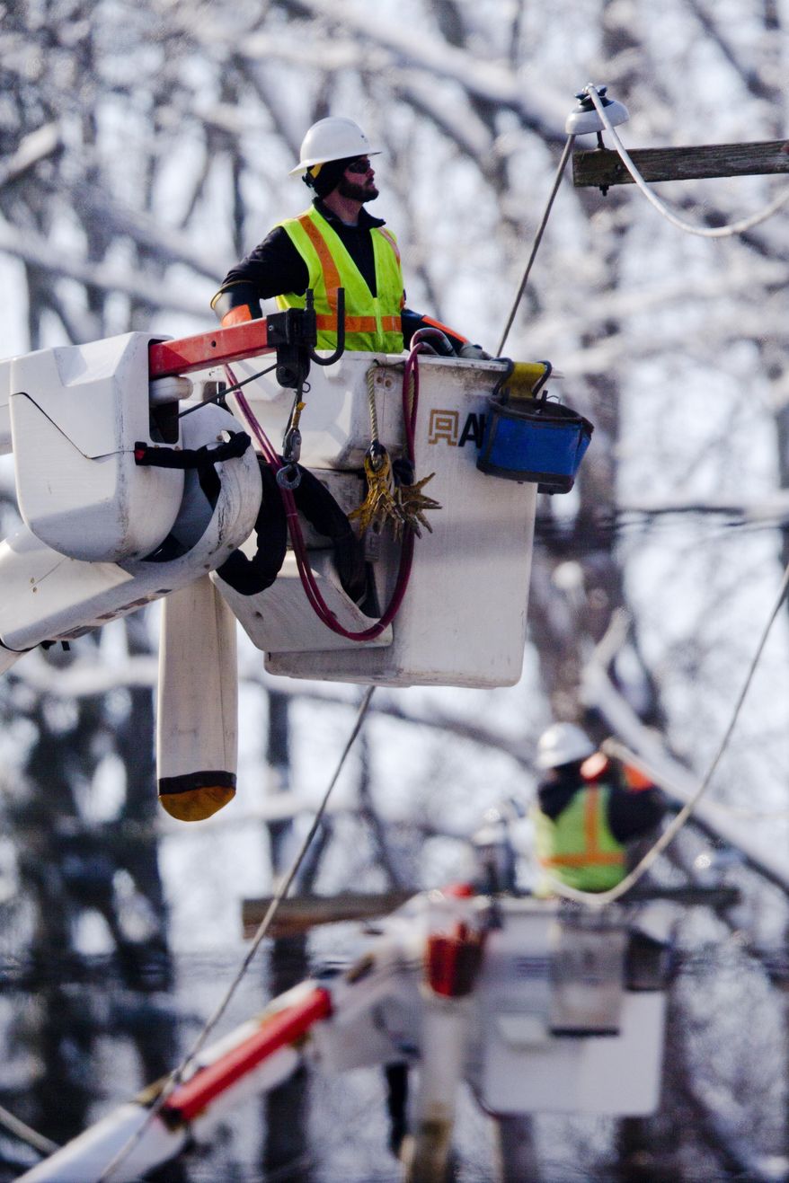 Linesman work to restore electrical power, Friday, Feb. 7, 2014, in Downingtown, Pa. A small army of electricity restoration crews labored Friday to reconnect about 330,000 customers in Pennsylvania and Maryland.  (AP Photo/Matt Rourke)