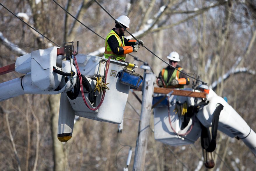 Linesmen work to restore electrical power, Friday, Feb. 7, 2014, in Downingtown, Pa. A small army of electricity restoration crews labored Friday to reconnect about 330,000 customers in Pennsylvania and Maryland.  (AP Photo/Matt Rourke)