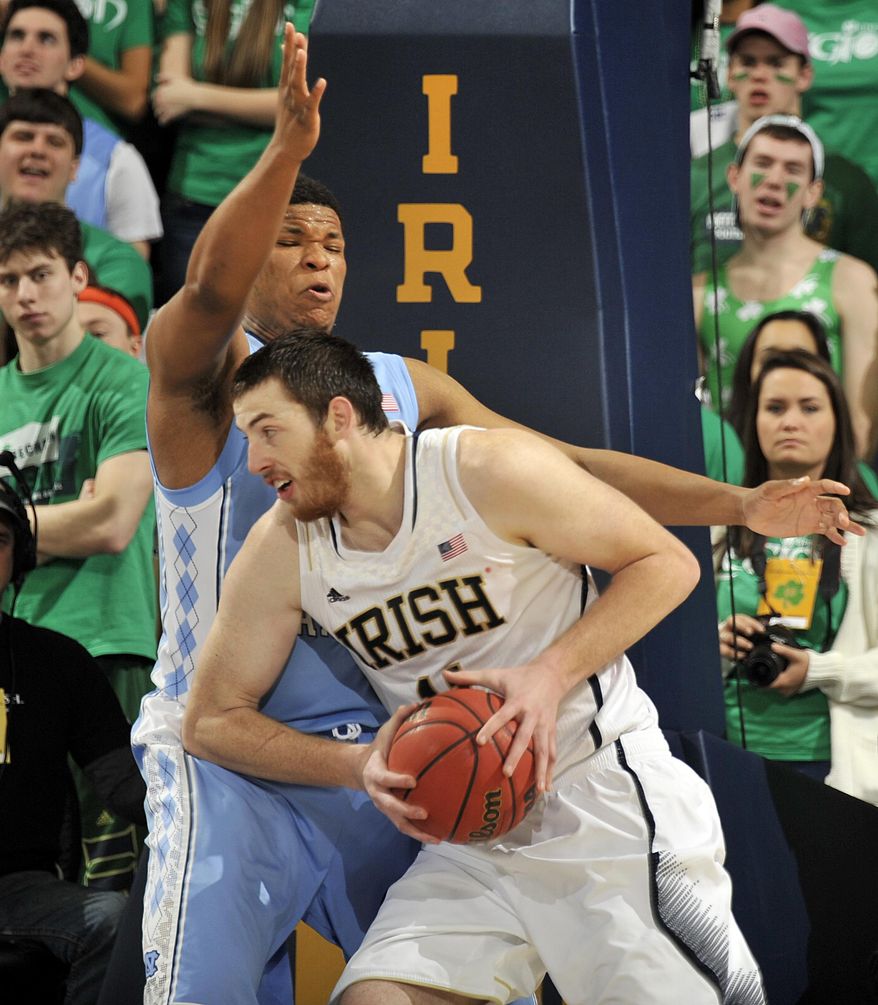 Notre Dame forward Garrick Sherman drives the lane as Nortrh Carolina forward Kennedy Meeks defends during the first half of an NCAA college basketball game Saturday, Feb. 8, 2014, in South Bend, Ind. (AP Photo/Joe Raymond)