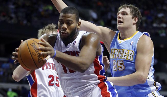 Detroit Pistons center Greg Monroe, front left, grabs a rebound in front of Denver Nuggets center Timofey Mozgov (25) during the first half of an NBA basketball game on Saturday, Feb. 8, 2014, in Auburn Hills, Mich. (AP Photo/Duane Burleson)