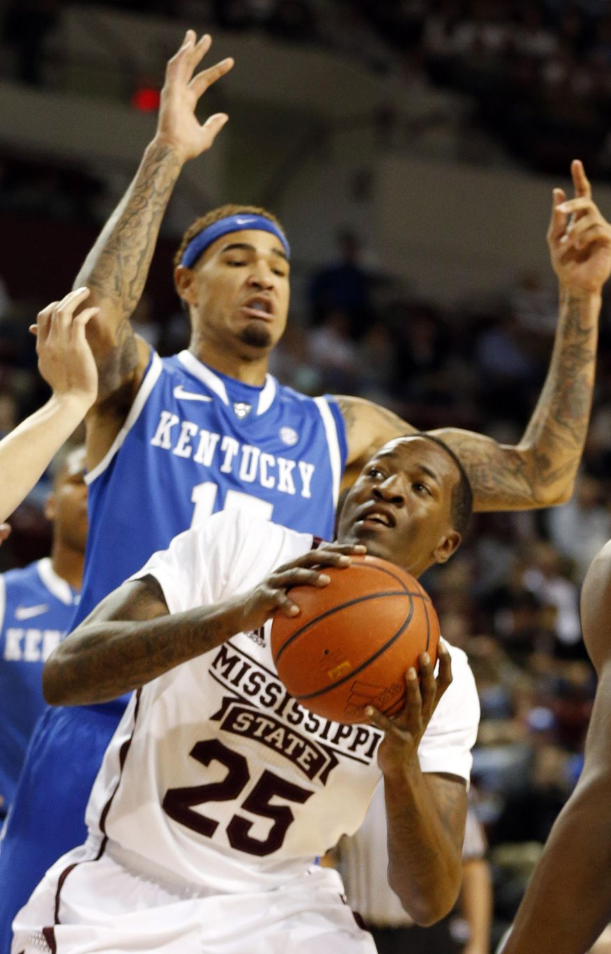 Mississippi State forward Roquez Johnson (25) looks for help as Kentucky forward Willie Cauley-Stein (15) defends over him in the first half of an NCAA college basketball game in Starkville, Miss., Saturday, Feb. 8, 2014. (AP Photo/Rogelio V. Solis)