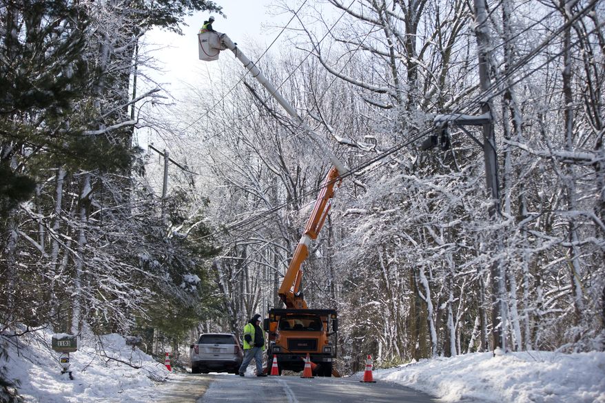 Linesmen work to restore electrical power, Friday, Feb. 7, 2014, in Downingtown, Pa. A small army of electricity restoration crews labored Friday to reconnect about 330,000 customers in Pennsylvania and Maryland.  (AP Photo/Matt Rourke)
