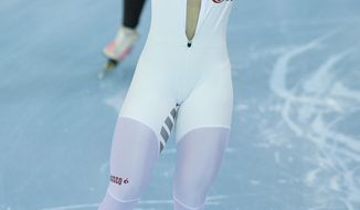 Bronze medallist Olga Graf of Russia celebrates with a wide open front of her skin suit after the women&#x27;s 3,000-meter speedskating race at the Adler Arena Skating Center during the 2014 Winter Olympics, Sunday, Feb. 9, 2014, in Sochi, Russia. (AP Photo/Pavel Golovkin)