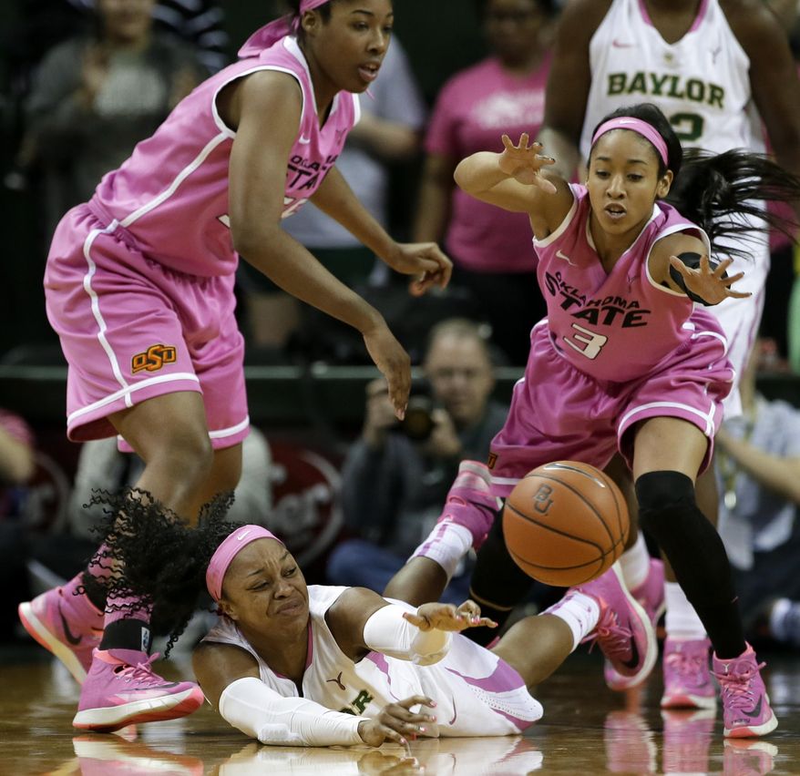 Baylor Bears' Odyssey Sims (0) passes the ball after winning control of it on a scramble on the floor against Oklahoma State 's LaShawn Jones, left, and Tiffany Bias (3) in the first half of an NCAA college basketball game on Sunday, Feb. 9, 2014, in Waco, Texas. (AP Photo/Tony Gutierrez)