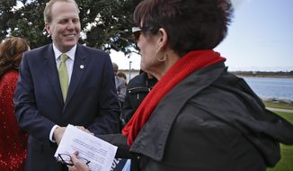 In a Monday, Feb. 3, 2014 photo, San Diego mayoral candidate Kevin Faulconer does a bit of handshaking during a campaign event, in San Diego. Faulconer easily topped a field of 11 candidates in a first round of voting by dominating in wealthier neighborhoods north of the freeway. (AP Photo/Lenny Ignelzi)
