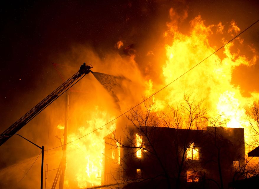Firefighters battle an apartment fire in Salt Lake City, Sunday, Feb. 9, 2014. The apartment building that was under construction. Agency spokesman Jasen Asay told The Associated Press that the Fire Department did a walkthrough of the building on Saturday. (AP Photo/The Salt Lake Tribune, Lennie Mahler)