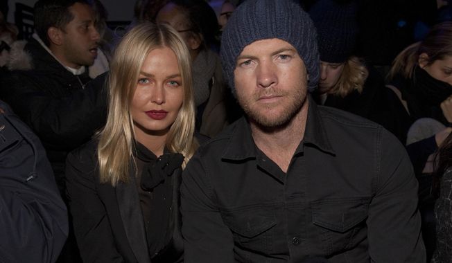 Fashion model Lara Bingle, left, and actor Sam Worthington, right, attend the MBFW 2014 Fall/Winter Alexander Wang fashion show, on Saturday, Feb. 8, 2014 in New York. (Photo by Andy Kropa/Invision/AP)