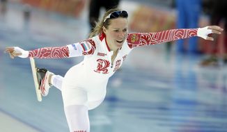 Russia&#x27;s Olga Graf celebrates her time after competing in the women&#x27;s 3,000-meter speedskating race at the Adler Arena Skating Center during the 2014 Winter Olympics, Sunday, Feb. 9, 2014, in Sochi, Russia. (AP Photo/Matt Dunham)
