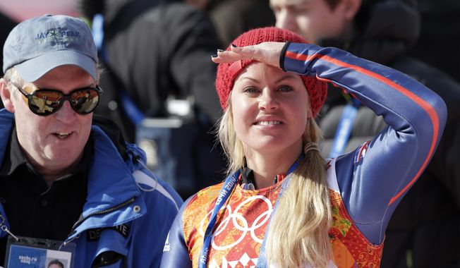 Britain's Chemmy Alcott shields her eyes from the sun after finishing the the downhill portion of the women's supercombined at the Sochi 2014 Winter Olympics, Monday, Feb. 10, 2014, in Krasnaya Polyana, Russia. (AP Photo/Gero Breloer)