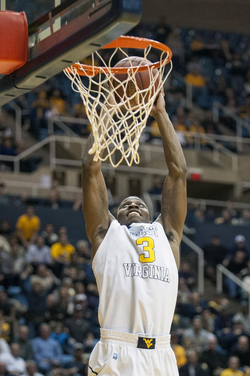 West Virginia's Juwan Staten (3) dunks during the second half of an NCAA college basketball game against Iowa State, Monday, Feb. 10, 2014, in Morgantown, W.Va. West Virginia won 102-77. (AP Photo/Andrew Ferguson)