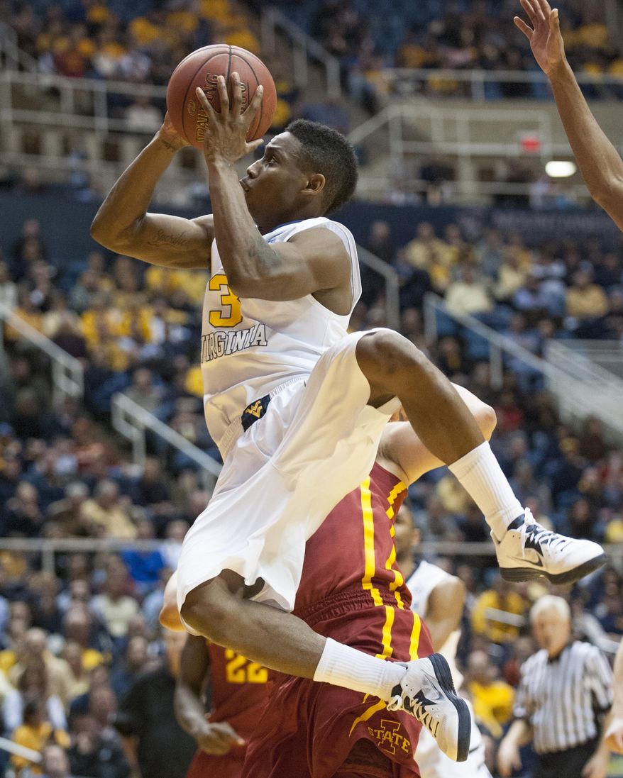West Virginia's Juwan Staten (3) drives to the basket during the second half of an NCAA college basketball game against Iowa State, Monday, Feb. 10, 2014, in Morgantown, W.Va. West Virginia won 102-77. (AP Photo/Andrew Ferguson)